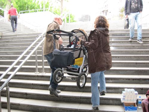 carrying-baby-stroller-upstairs