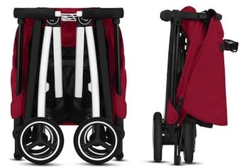 A  GB Pockit stroller with a red canopy folded up into a petite square.
