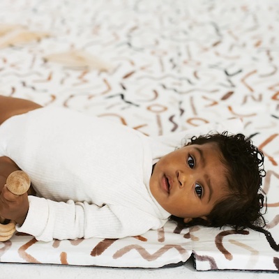 How early can baby go on play mat